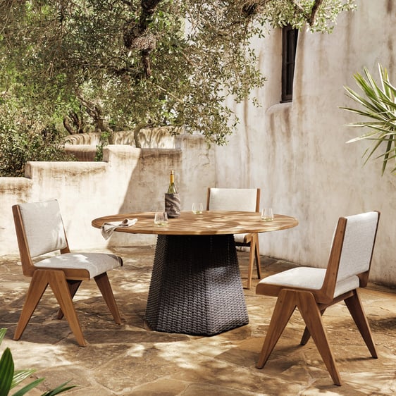 Outdoor dining area with table and chairs made from sustainably sourced materials.