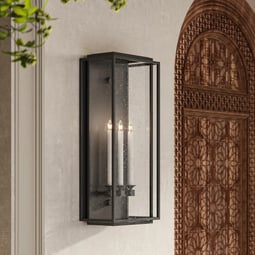 Modern outdoor wall sconce with black metal frame and glass panels, featuring candle-style bulbs for elegant exterior lighting.