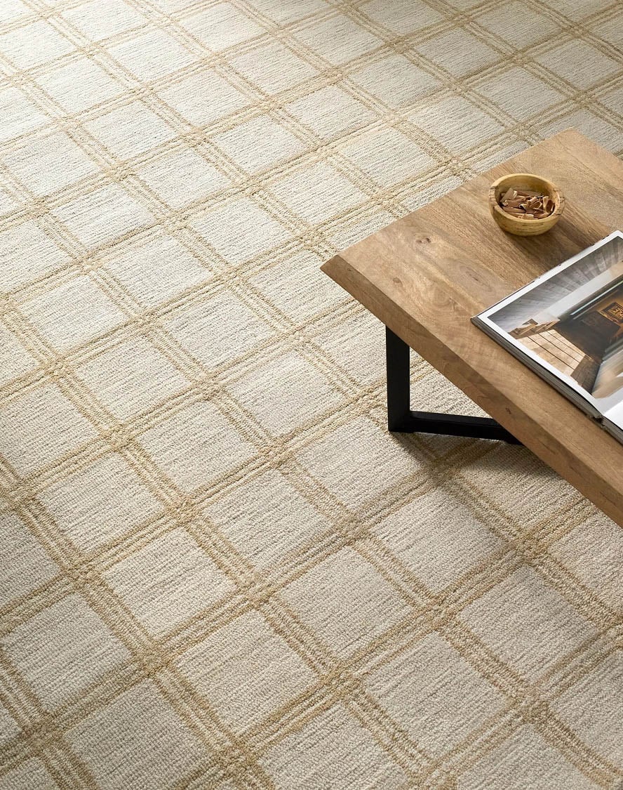 Modern living room with an ivory plaid area rug featuring subtle texture and neutral tones, ideal for adding understated elegance to any space on a designer rug site.