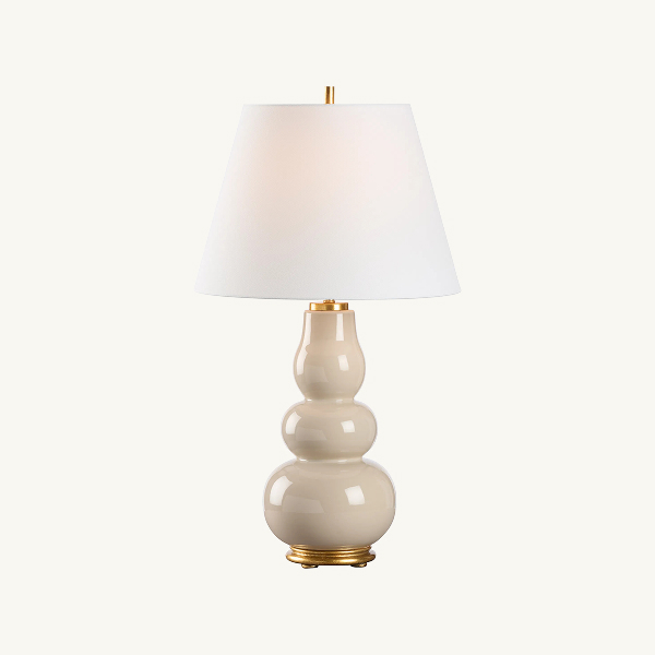 Neutral ceramic table lamp with white shade and brass accents