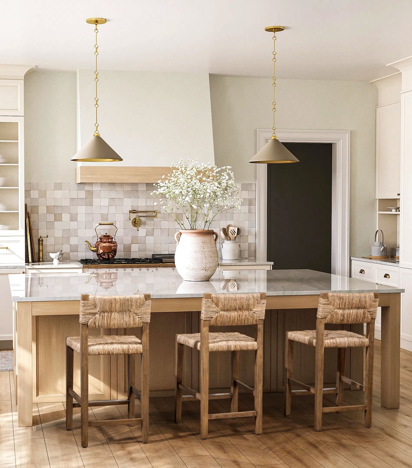 Light-filled kitchen with wood island, woven counter stools, and brass pendant lighting