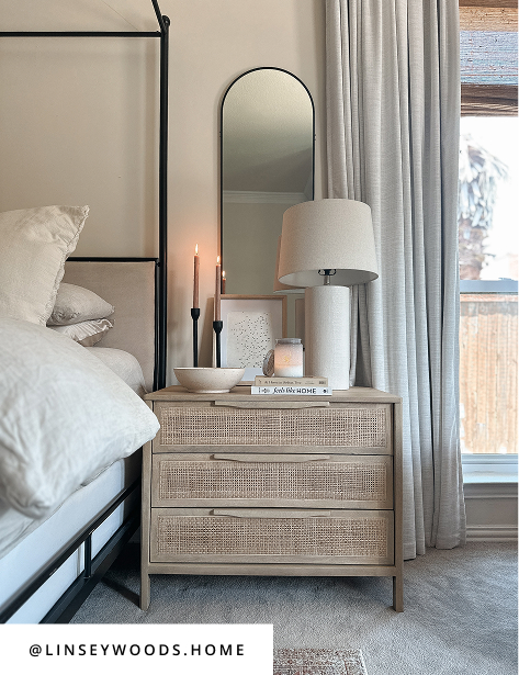 Neutral bedroom with three drawer wooden nightstand