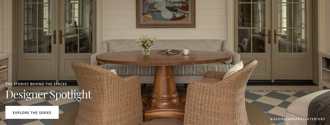 Dining nook with round wood table, woven chairs, and built-in banquette seating.
