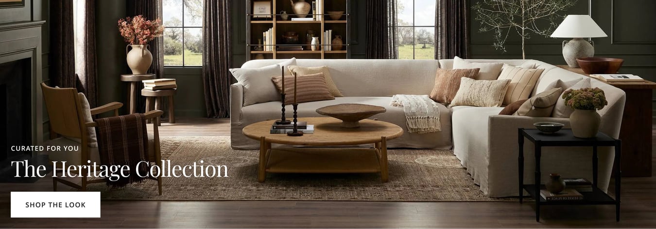 Neutral living room with sectional sofa, wood coffee table, and layered heritage-style decor.