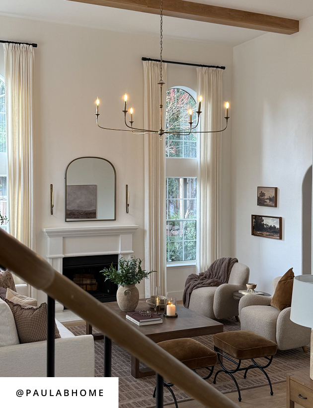 Neutral living room with upholstered seating, wood coffee table, and modern chandelier