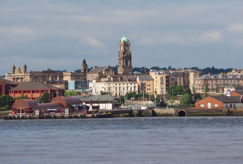 View of Birkenhead skyline across the Mersey river in Liverpool, UK