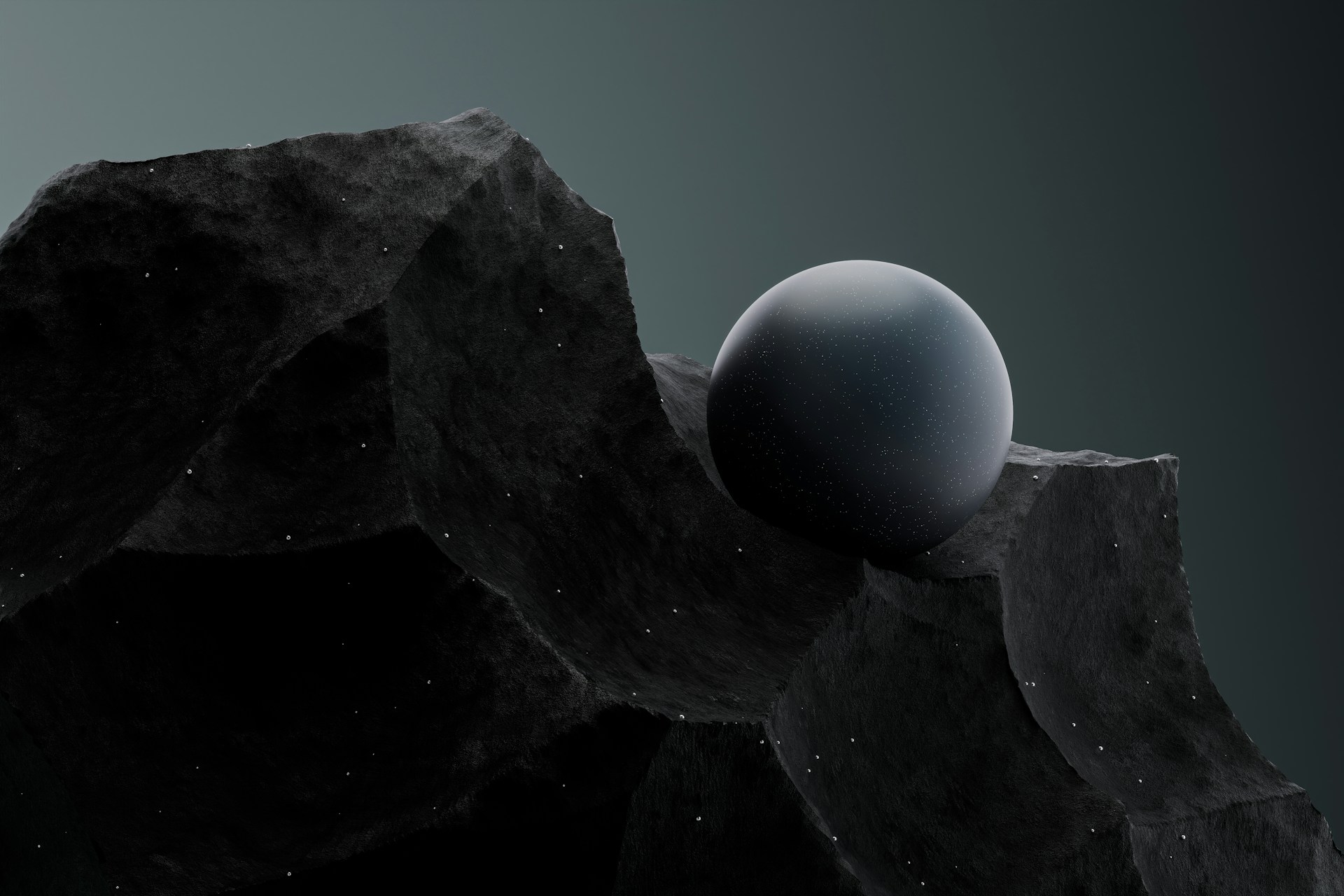 Smooth dark sphere resting in a notch of jagged black rock