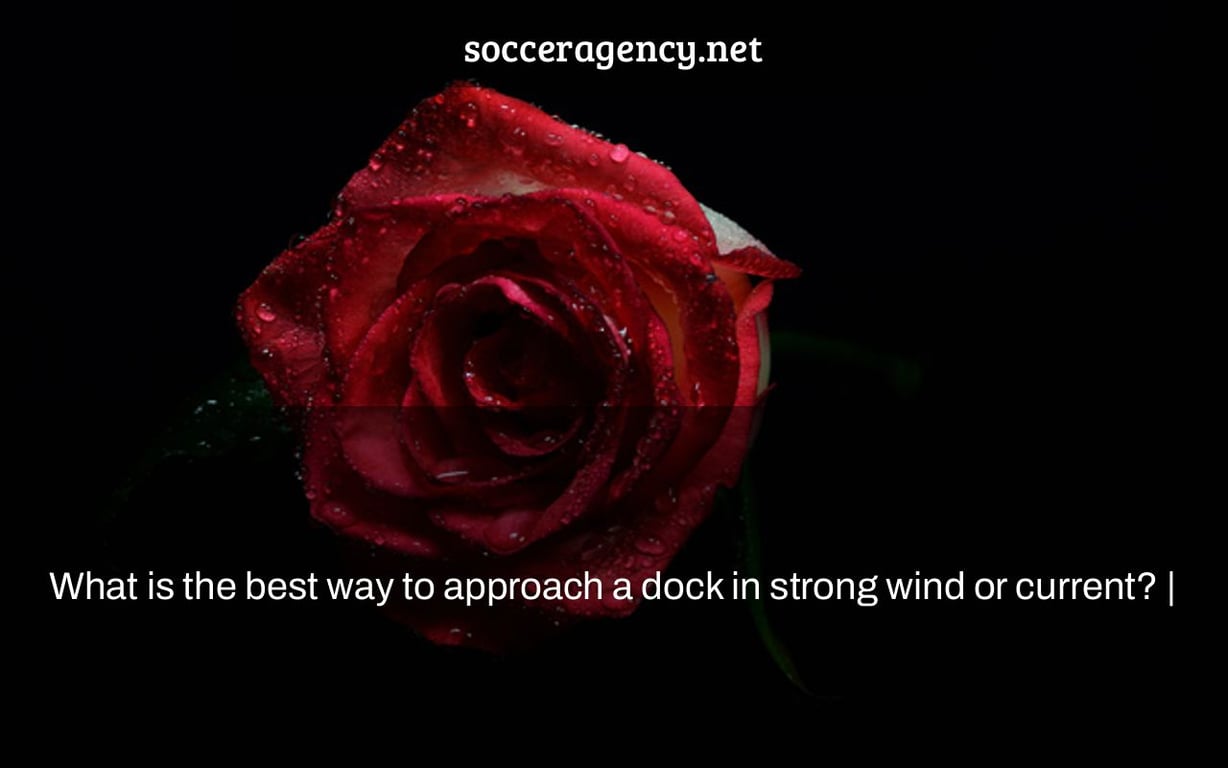 What is the best way to approach a dock in strong wind or current? |