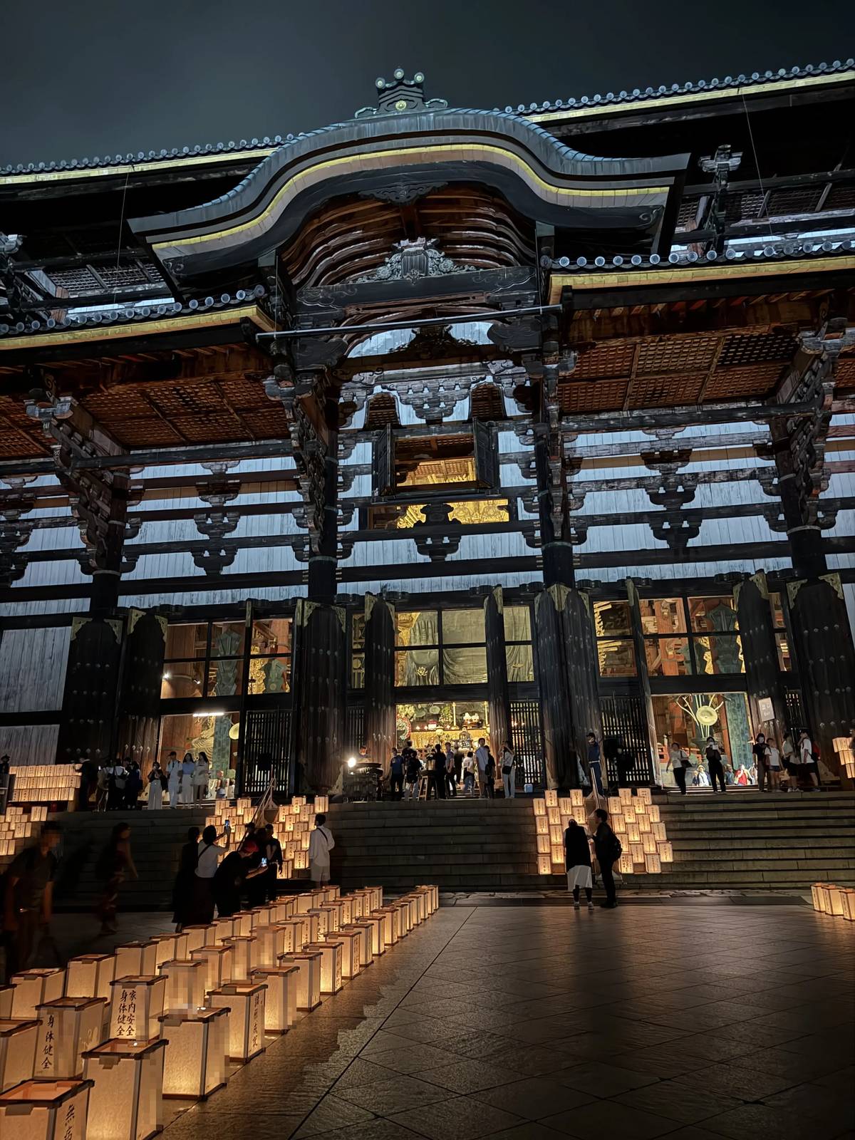 The Great Buddha Hall of Todai-ji at night during the Manto Kuyo-e, with rows of lanterns