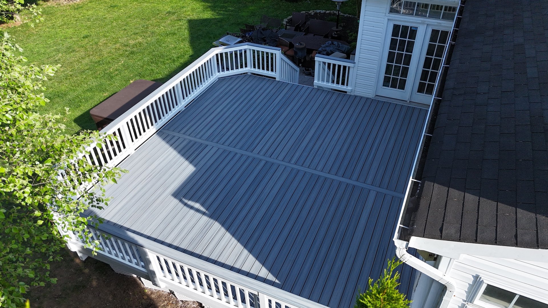 Upgryd deck resurfacing project in Allentown, PA featuring a Trex deck with a foggy wharf color scheme, showcasing the beauty and craftsmanship of the custom deck.