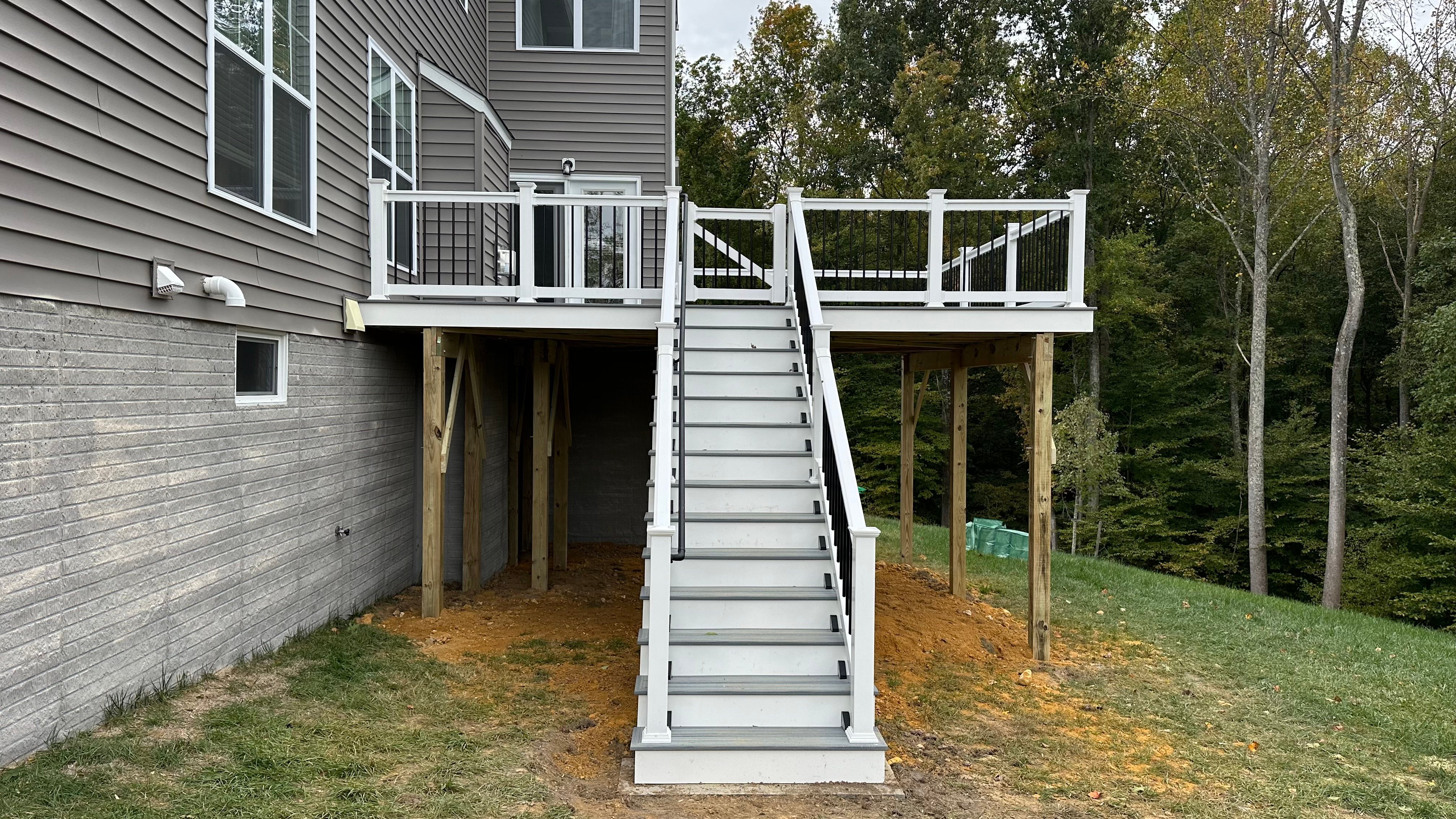 Upgryd deck with white vinyl railings and a staircase, perfect for enjoying the outdoors in Fogelsville, PA.