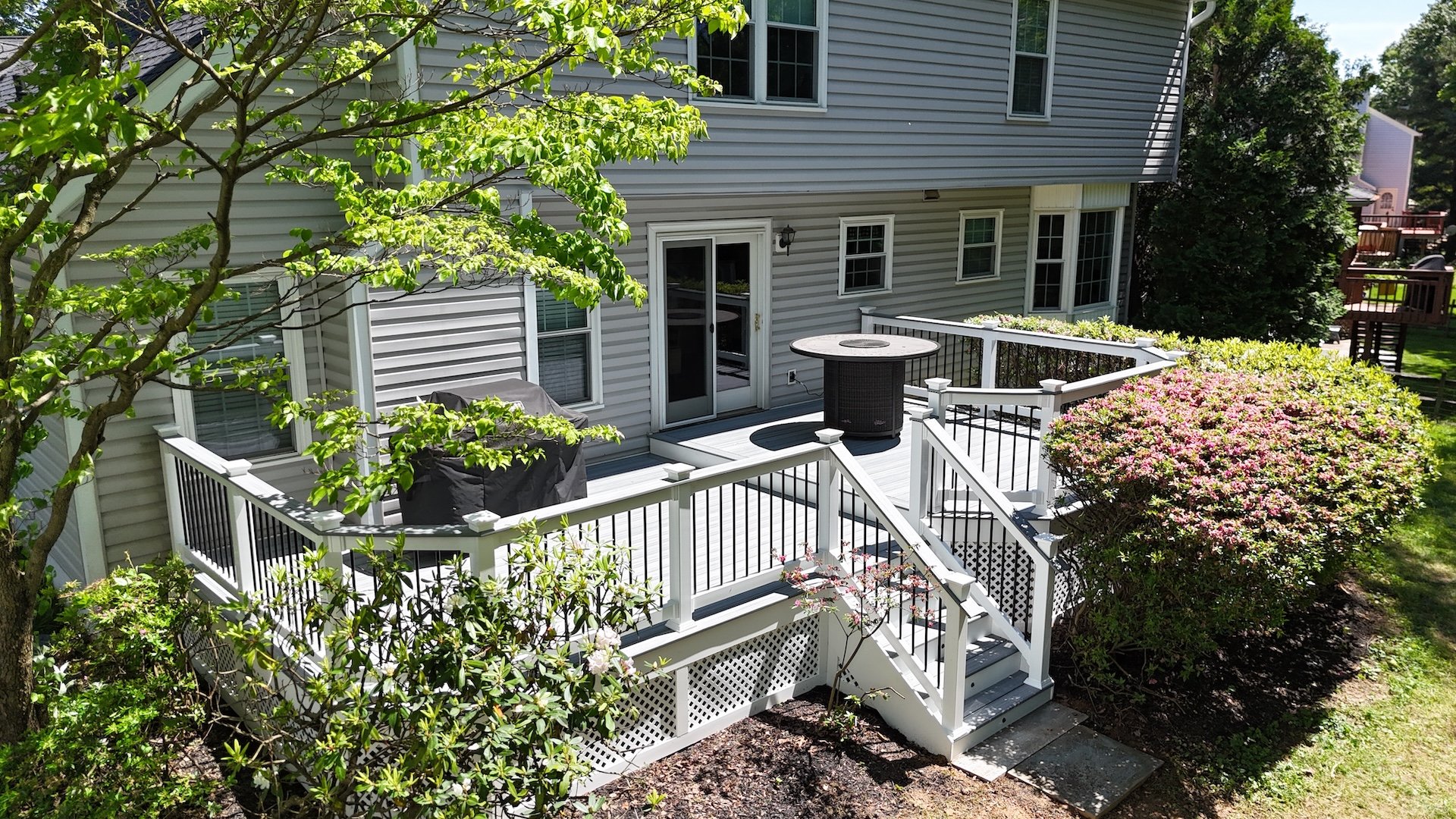 Upgryd custom deck with white lattice and stairs in Allentown, PA.