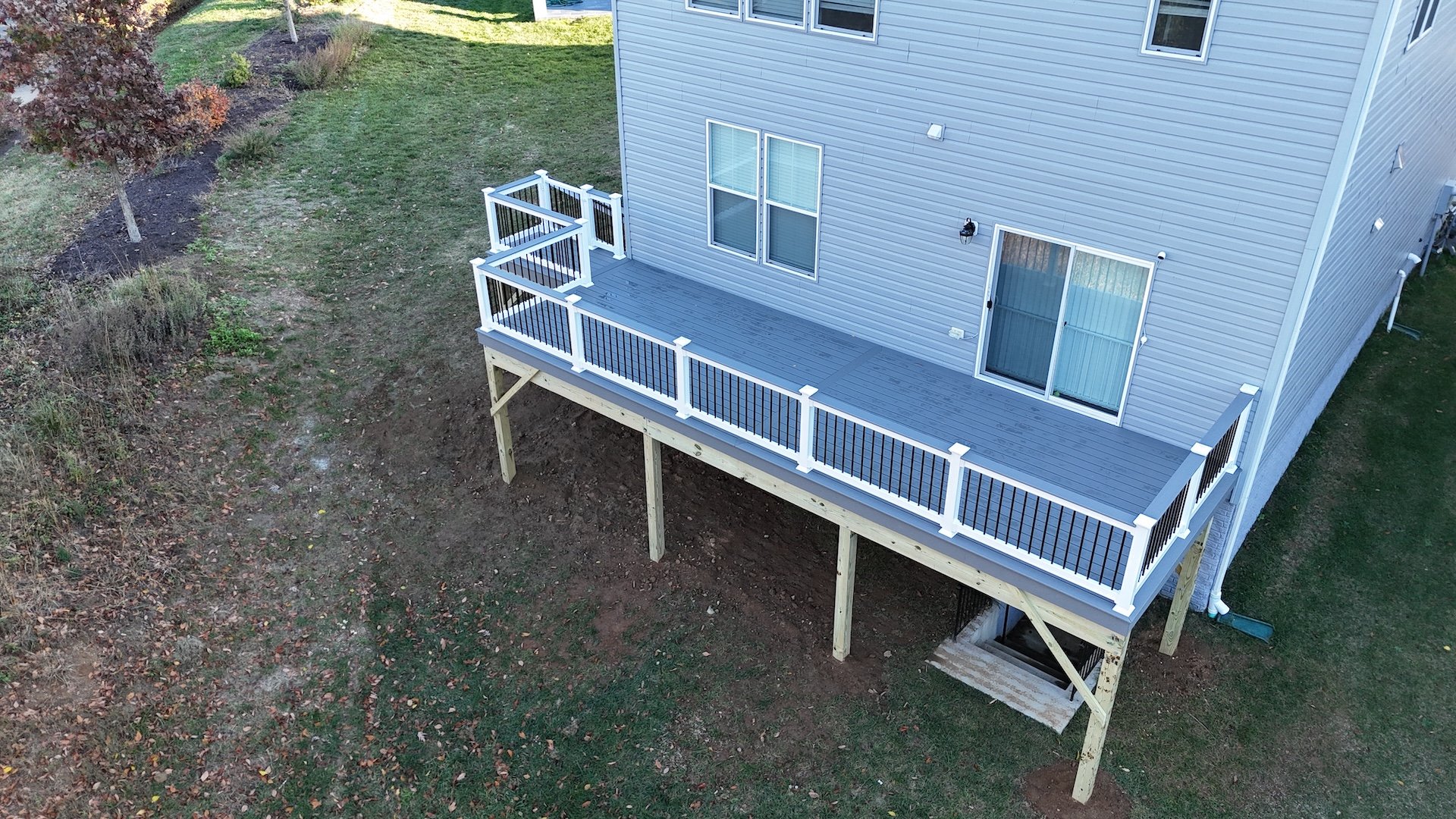 Upgryd aerial view of a custom deck with pebble gray Trex decking in Cetronia, PA.