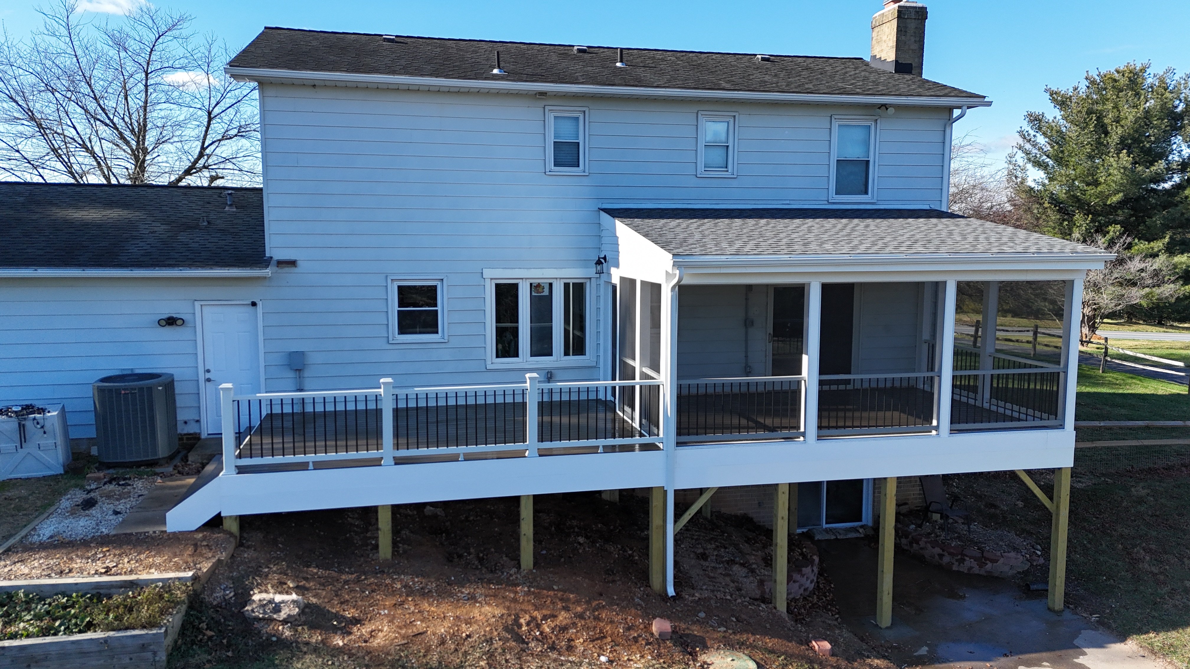 Upgryd's stunning covered porch deck in Schnecksville, showcasing a cozy space with spiced rum-colored accents and inviting front features.