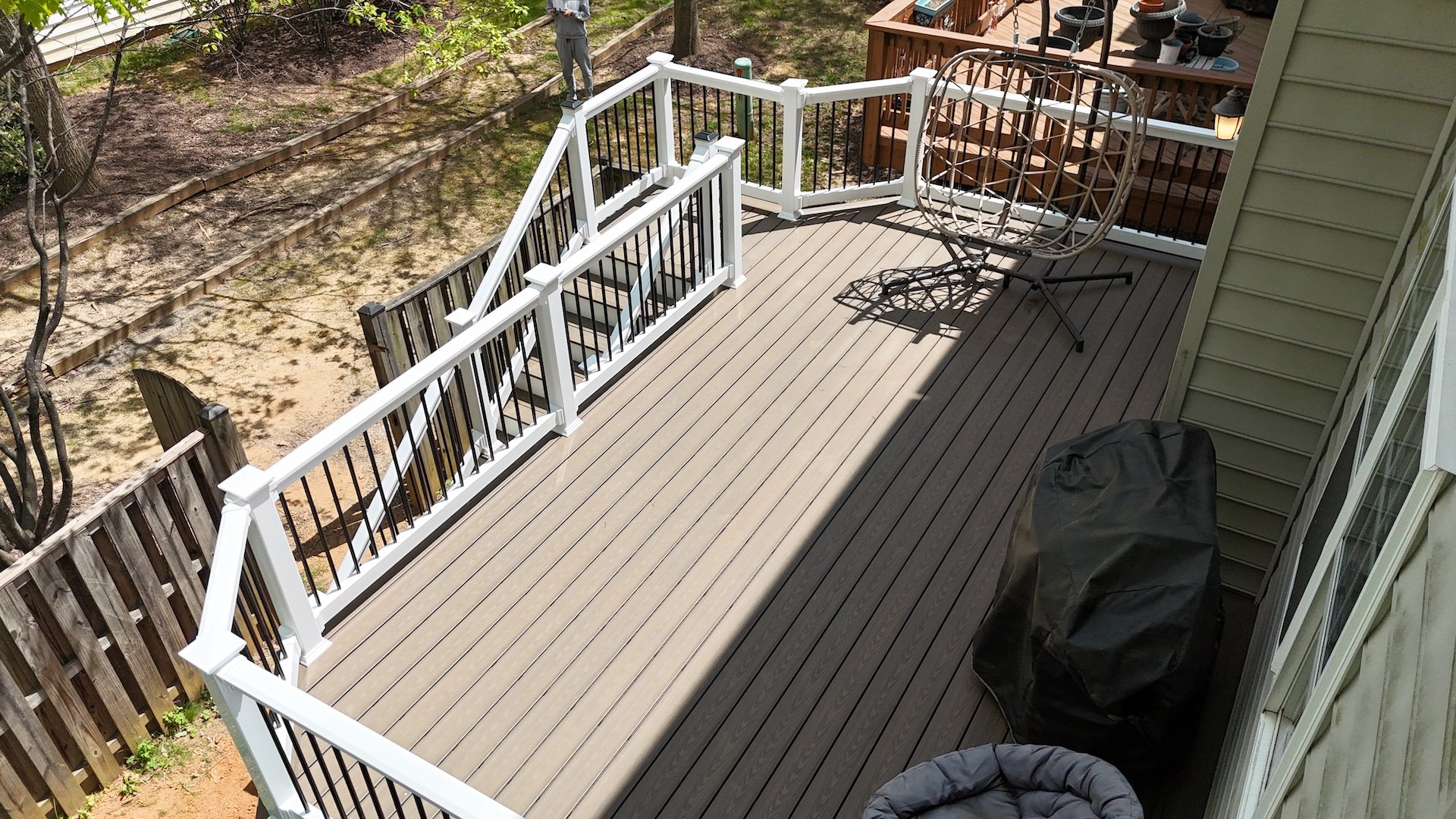 Upgryd decking with aluminum balusters and Trex Tide Pool decking, a beautiful outdoor living space.