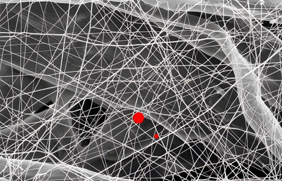 A zoomed in image where you can clearly see synthetic air filter media fibers stopping and capturing very small dirt and dust particles, stopping them from entering your car's engine and causing wear.