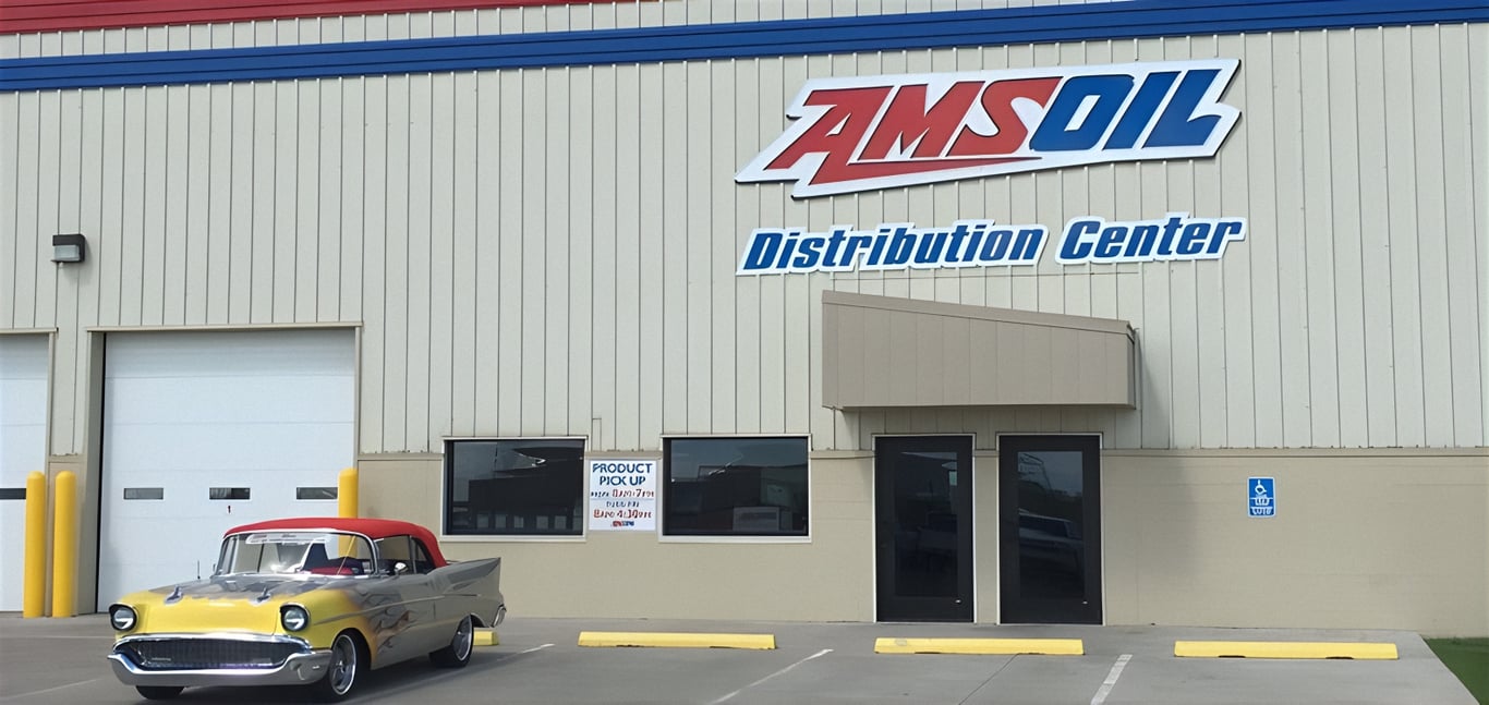 A picture of AMSOIL's main Distribution Center in Superior, Wisconsin, with a classic car parked in front of it.