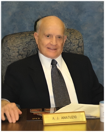 Lieutenant Colonel Albert J. Amatuzio, AMSOIL INC. founder and president and CEO sitting at his desk.