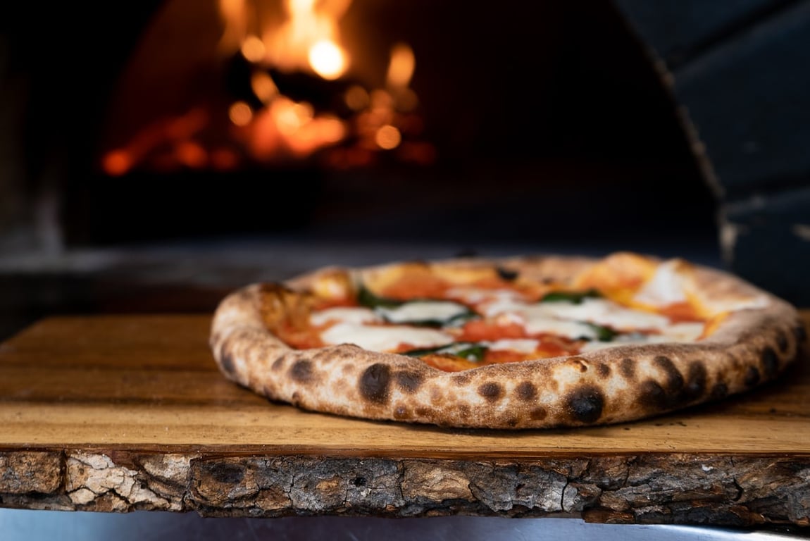 Pizza coming out of the oven