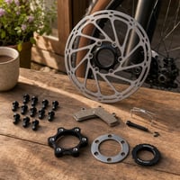 Sada na brzdy: 180mm Center Lock kotúč + 12x skrutky + brzdové platničky + adaptér 1