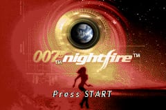 The title screen features a large golden circular lens or scope with a crosshair reticle in the center, set against a red gradient background with circuit board-like patterns. The text "007 nightfire™" appears in silver lettering in the upper-left area of the screen. Below the main graphic, "Press START" is displayed in white text at the bottom center. The overall design uses a red, gold, and black color scheme with a spy-themed aesthetic.