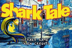 The Shark Tale title logo appears in large yellow text at the top of the screen, with a stylized blue shark graphic positioned to the left. Below the title, a dark underwater cityscape with blue-tinted buildings and structures forms the background. Two menu options are centered at the bottom in white text: 'START GAME' and 'VIEW CREDITS'. The overall color palette is dominated by blues and yellows against a nighttime urban aquatic setting.