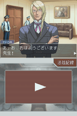 A dialogue scene in an office interior shows a man with white hair wearing a blue suit and red tie, standing with arms crossed in the center. Two other characters stand in the background near a brown door and couch. Japanese text appears in a dialogue box at bottom left. Below is a video playback interface with a white play button centered on a red horizontal-line patterned background. The art style uses anime-influenced character designs typical of DS-era visual novel games.