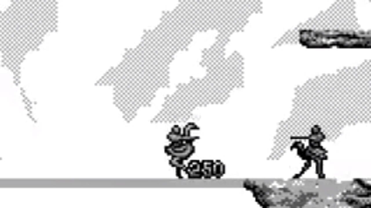 A Game Boy screenshot showing two pixelated characters on a gray platform against a white background with diagonal gray pattern elements. The left character is a round creature with a smiling face displaying the number 250 below it. The right character is a humanoid figure in a shooting pose. A dark rocky surface is visible at the bottom of the screen. The sprite art is rendered in monochrome black and gray tones typical of early Game Boy graphics.