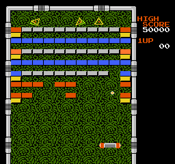A brick-breaking level shows multiple rows of colored blocks stacked at the top of the screen—orange, yellow, blue, and green bricks arranged in horizontal lines. A small paddle sprite appears near the bottom center of the playing field against a green textured background. The top-right corner displays score information reading "250 50000" and "1UP" with circular score symbols. The screen is bordered by a white frame, with brown-orange sections at the top and sides. A single ball sprite is visible in the lower portion of the playing area.