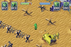 A top-down tactical view of a sandy desert battlefield with green plastic soldier units positioned across the terrain. A green commander figure stands centrally, surrounded by blue-uniformed soldiers in formation on the left and a yellow vehicle with mounted weapon on the right. The HUD displays unit count indicators at the top showing troop numbers, with a beige-tan color palette dominating the level background. Pixelated sprite graphics and isometric perspective are characteristic of Game Boy Advance rendering.