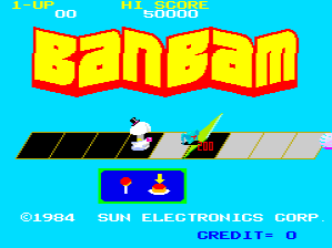 The BanBam title screen displays the game's logo in large yellow text with red shading at the top. Below it, a cyan-blue background shows a simple scene with a small character sprite on the left side of a dark angled platform and a yellow projectile or enemy sprite on the right. A blue UI panel sits centered below the platform containing red and yellow icon graphics. Score displays reading "1-UP" and "HI-SCORE" appear in the top-left and top-center corners in a cyan banner. Copyright text "©1984 SUN ELECTRONICS CORP" is positioned at the bottom-left of the screen.