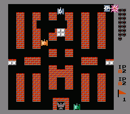 A two-player Battle City level display shows a symmetrical brick maze in red-orange with two tanks positioned in opposite corners—one labeled IP in the upper right, one in the lower left. A gray eagle symbol sits centered at the bottom, flanked by two small white square bases. The playfield is bordered by solid brick walls. A vertical score panel on the right edge displays player statistics and numbers. The entire scene uses a low-resolution 8-bit sprite style typical of mid-1980s arcade-to-console ports.