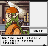 A character with orange hair and clothing stands in an indoor shop setting with shelves and equipment visible in the background. The left side displays the character sprite in orange and brown tones against a warm interior environment. A white rectangular dialog box on the right contains the Shop UI label and text reading "We've got plenty of them lying around." The graphics use NGPC-style pixel art with a limited color palette typical of late-1990s handheld gaming.