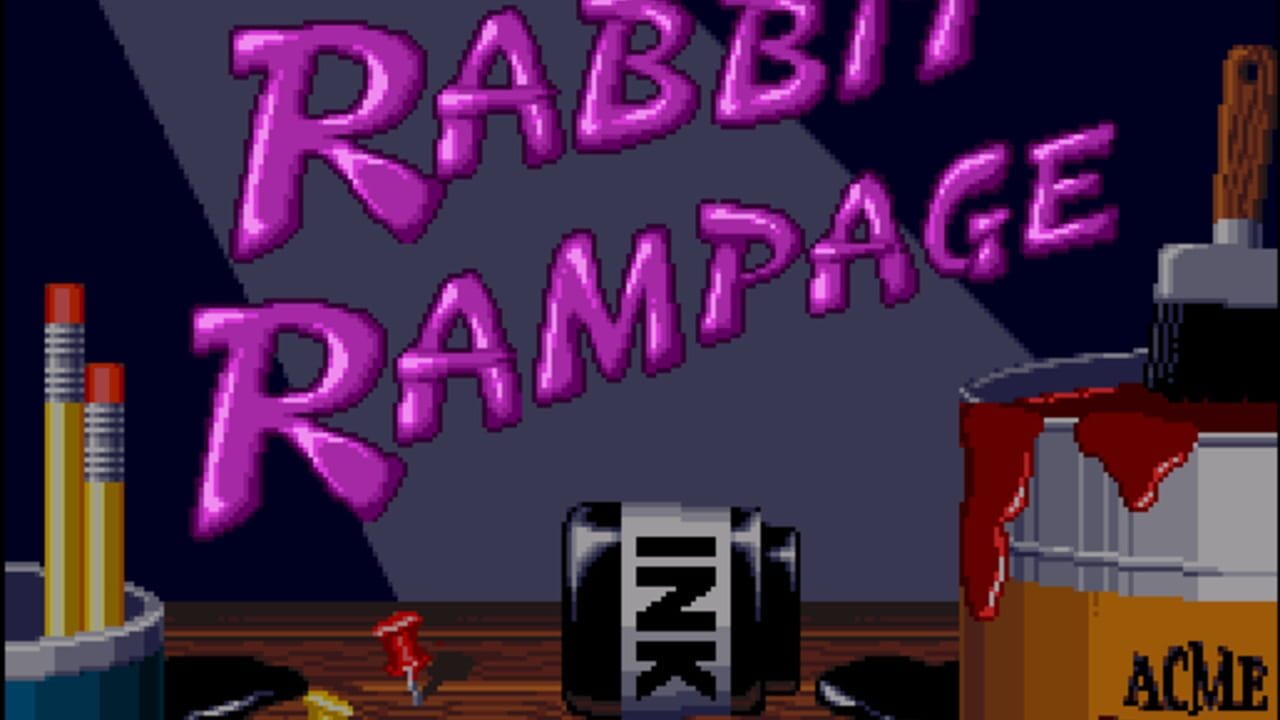 The title screen displays 'RABBIT RAMPAGE' in large magenta pixelated letters against a gray background. A small red cartoon character stands on a wooden platform in the center. To the left are yellow and red pencils in a holder. On the right side is a wooden structure with a red cloth draped over it and an 'ACME' box below. The scene uses a limited 16-bit color palette with brown wood textures, dark blue sky, and metallic gray elements.