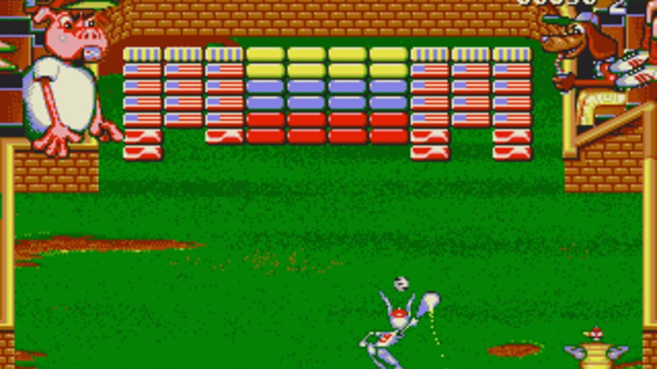 A brick-breaking puzzle game displays a grid of colorful blocks at the top of the screen arranged in rows of yellow, purple, and red. A small character sprite with red and white coloring stands in the center-lower area of a green grass field bordered by brown brick walls. A dotted line trajectory extends from the character upward toward the block grid. Additional small sprites appear in the bottom corners, with a pink pig-like character visible in the upper left. The art style features pixelated 8-bit graphics with a bright color palette typical of early 1990s computer games.