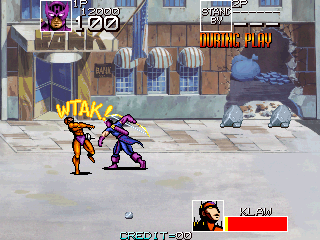 Two characters in bright costumes—one yellow and red, one purple—face each other on a city street. A gray vehicle sits in the background near brown storefronts with arched doorways and windows. The HUD displays a character portrait in the lower left with red health bar, numbered score "CREDIT 80" at bottom center, and blue explosion effects visible mid-screen. Pixelated sprite-based graphics in arcade style with a tan pavement ground plane.