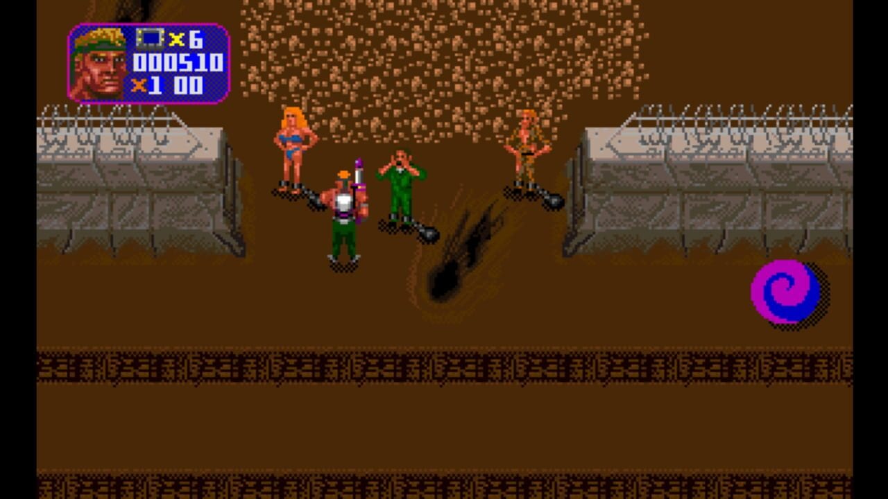 A top-down arena scene displays a player character in green outfit wielding a gun in the center, surrounded by three enemy fighters in various colored costumes positioned around the arena. Two metal fences frame the left and right sides, with a brown textured wall in the background and scattered falling debris or particles from above. A pink spiral logo appears in the lower right corner. The HUD in the upper left shows a portrait icon, multiplier counter reading 6x, score of 000510, and 100 remaining. Pixel art uses a limited palette of greens, reds, blues, and browns rendered in low resolution typical of early 1990s DOS graphics.