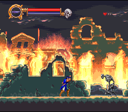 A blue-clad protagonist stands on a stone platform in the center-left of the frame, surrounded by intense orange and yellow flames consuming structures behind him. A stone arch and architectural ruins burn in the background across multiple depth layers. The top-left corner displays a health bar in red and an icon, while the top-right shows additional UI elements. The scene uses a 16-bit sprite art style with warm fire effects rendered in orange and yellow against darker background elements, creating a sense of a castle interior engulfed in flames.