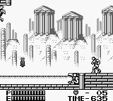 A monochrome Game Boy screen displays a cityscape level with tall buildings rendered in line-art style against a light background. A small sprite character stands on a platform in the lower-left portion of the screen. The bottom of the screen shows a HUD bar with time counter reading 635 and what appears to be inventory or status information. The architectural elements feature repeating vertical columns and windows typical of 8-bit platformer environments.