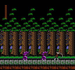 A side-scrolling level displays a protagonist character in the center-lower area, surrounded by purple enemies. The background features tall brown tree-like structures with green foliage at the top, creating a forest setting. A green brick platform forms the ground level with orange text panels at the bottom showing score or status information. The color palette consists of green, brown, purple, and orange pixels against a black background, rendered in 8-bit NES-era sprite resolution.