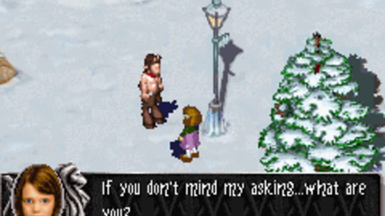Two pixelated characters stand in a snowy outdoor scene with a decorated Christmas tree on the right and a lamp post in the center. The character on the left wears brown clothing with a red scarf, while the character below wears purple. A dialogue box at the bottom displays text reading 'If you don't mind my asking...what are you?' The background shows a light blue sky and white snow covering the ground and vegetation. The art style uses isometric perspective with low-resolution sprites typical of Game Boy Advance graphics.