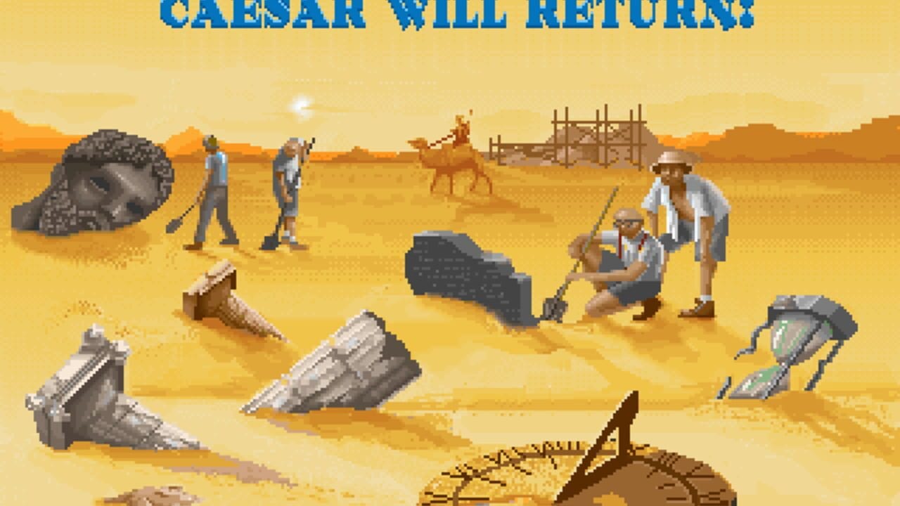 A desert landscape with tan and yellow terrain shows archaeological ruins and construction activity. Blue text at top reads "CAESAR WILL RETURN!" Several pixel-art human figures in light-colored clothing stand across the sandy ground. Scattered stone architectural fragments and debris are visible in the foreground and middle ground, along with a wooden palisade fence and a camel in the background. The sun appears low on the horizon, casting an orange glow across the scene. Pixelated sprite-based graphics with a warm color palette typical of 16-bit era game artwork.