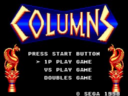 The Columns title screen displays the game's name in large golden letters with orange decorative flames at the top center. Below, white text lists menu options: Press Start Button, 1P Play Game, VS Play Game, and Doubles Game. Matching golden flame ornaments flank both sides of the screen. A SEGA 1990 copyright notice appears in the bottom right corner against a black background.