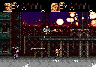A split-screen gameplay view showing two armed soldiers positioned at different heights on an industrial platform level. The left screen displays a soldier in profile against a dark background with grid-pattern walls, while the right screen shows another soldier amid an intense scene with large glowing orange and white explosions filling the upper portion of the screen. Both players have health bars and weapon indicators at the top. The level features metal scaffolding, industrial architecture, and heavy use of reds, oranges, and purples in the background, typical of 16-bit sprite-based action game visuals.