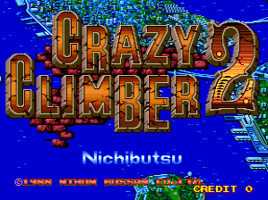 The arcade title screen displays large golden letters spelling 'CRAZY CLIMBER 2' centered on a bright blue background, with red and orange accent colors. Below the title, white text reads 'Nichibutsu'. At the bottom, a red copyright notice and 'CREDIT 0' appear in small pixelated text. A small Nichibutsu logo is visible in the lower left corner. Building structures and architectural elements are partially visible in the background behind the main title text.