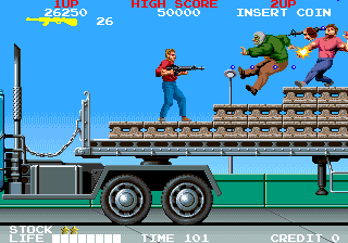 A red-shirted player character stands on a green truck bed against a bright blue sky with downtown buildings in the background. Two enemies in blue and red clothing leap through the air above the truck. The top HUD displays score, high score, time, insert coin prompt, and credit indicators in red and yellow text. The bottom shows "STICK" and "TIME 101" along with a "CREDIT 1/5" counter. Pixel-art sprites are rendered in primary colors against flat colored backgrounds with a side-scrolling perspective.