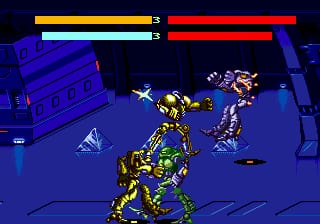 A yellow and black armored cyborg character stands centrally on a blue metallic floor in an industrial interior space. Two health/energy bars appear at the top of the screen: a yellow bar on the left showing 3 units and a red bar on the right also showing 3 units. Scattered debris and mechanical objects are visible around the cyborg, with blue architectural structures forming the background walls. The sprite uses a detailed pixel style typical of early Sega Genesis arcade ports.