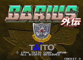 The title screen displays "DARIUS" in large green and pink gradient letters at the top, with "GAIDEN" and "SILVER HAWK" text below. A Taito Corporation logo appears in the center, featuring a metallic shield emblem with a red jewel and gold banner. The background shows a brown textured landscape. Copyright information and "CREDIT 0" appear at the bottom of the screen in white text. The overall aesthetic uses pixel art typical of early 1990s arcade hardware.