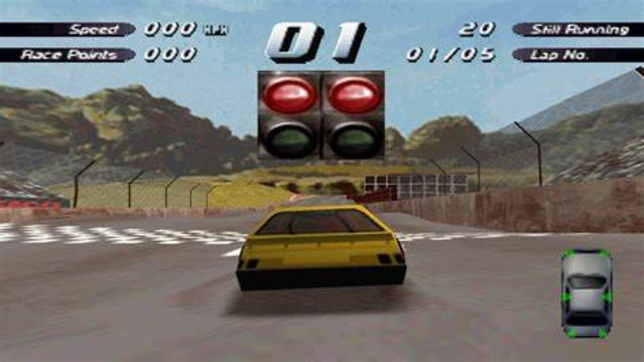A yellow car sits at a starting line on a race track with mountainous terrain in the background. A traffic light with red and green lights is visible above the track. The HUD displays Speed (000 km/h), Race Points (000), and Stint Running (20) with Lap No. 01/05 in the upper corners. A green-outlined minimap appears in the lower right showing the player's vehicle position. Fencing and rocky hills frame the scene under a light blue sky.