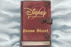 A burgundy book-shaped menu screen dominates the center, decorated with gold ornamental borders and the Disney Princess logo at the top. Below the logo, gold text reading "Press Start" is centered on the book cover. The background shows a cloudy sky with soft gray and white tones, creating a storybook-like atmosphere. The overall composition resembles an open storybook with decorative medieval-style flourishes framing the interface elements.